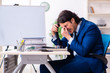 © Elnur - Young businessman sitting and working in the office