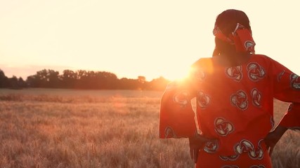 hd video clip of african woman farmer in traditional clothes standing hands on hips in a field of cr