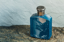Blue Aftershave Bottle On Wet Stone Texture