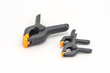 © v_sot - Black plastic clamps. Set of small and big size. Clamping equipment for handicraft, joinery and photography. White background.