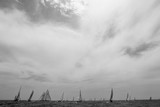 Fototapeta Londyn - Vintage yachts race in Barcelona. Old ships and boats in the sea. Black and white photos of nautical sports in the ocean. Regatta in mediterranean sea. Sails, mast, sheet, canvas in the sky. Holidays