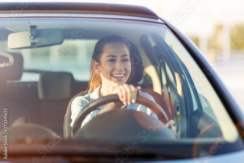 Happy woman driving a car and smiling Tableau sur Toile