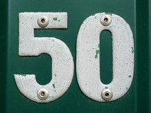 House Number Fifty. White Number Fifty On Green Background