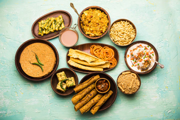 Wall Mural - Group of Gujarati snacks like jalebi-fafda, thepla, khaman dhokla, aloo bhujiya, khandvi,khakra, dahi vada, gathiya with hot tea