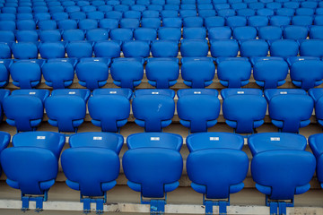 Wall Mural - Rows of blue seats in the stand in the sports arena