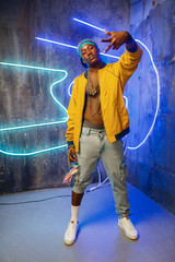 Wall Mural - Black rapper in underpass neon light on background