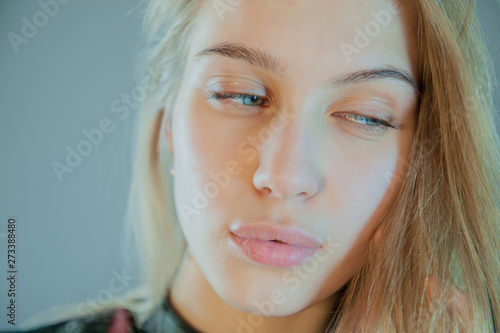 Beautiful Blonde With Blue Eyes In Plaid Dress Touches Her Hair