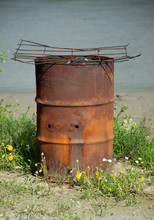Old Rusted Metal Barrel With Grill Over Top