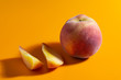 © vladimir - juicy fresh ripe peach on orange matte background