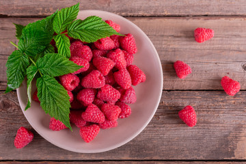 Sweet fresh organic raspberries background close-up. Fresh and sweet raspberries background