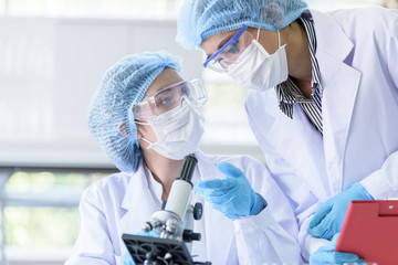 Asian scientist team has researching in laboratory.