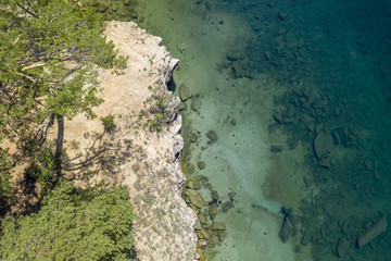  Lake with turquoise water, green trees; montain in the background; reflection in the water; beautiful summer landscape lake surrounded by forest; aerial drone shot over beautiful mountain forest lake