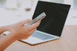 © 88studio - woman holding mobile smart phone using app. female typing on computer