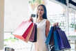 © 88studio - woman with shopping bag & credit card. shopaholic consumerism lifestyle