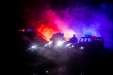 Police Cars At Night. Police Car Chasing A Car At Night With Fog Background. 911 Emergency Response PSelective Focus