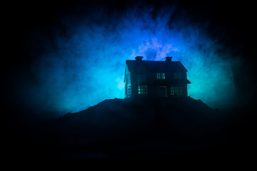 Wall Mural - old house with a ghost in the forest at night or abandoned haunted horror house in fog. old mystic b