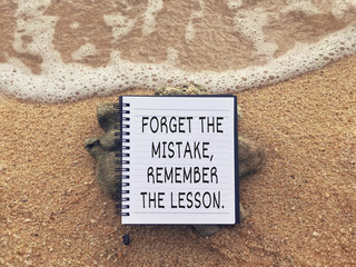 Wall Mural - Motivational and inspirational wording - Forget The Mistake, Remember The Lesson written on a notebook.