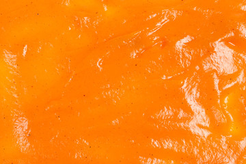 Wall Mural - Orange sauce splashes as background.