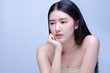© fongleon356 - Thoughtful amature beauty. Side view of thoughtful amature asian woman holding hand on chin and looking away while standing against blue background.