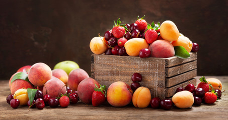 Wall Mural - fresh ripe fruits in a wooden box