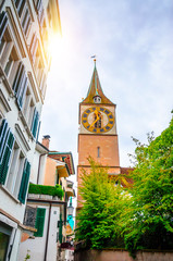 Wall Mural - Beautiful cozy street and tower of Saint Peter church in the city center of Zurich, Switzerland