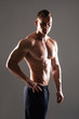 © Acronym - Strong, fit and sporty bodybuilder man over black background.