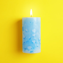 Alight scented wax candle on color background