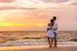 © Maridav - Honeymoon couple walking on sunset romantic stroll on Lover's key beach in Florida enjoying evening light relaxing on tropical summer vacation travel holiday. Two adults silhouettes lifestyle.