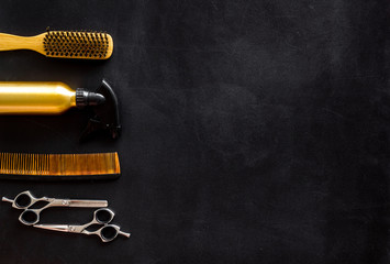 Sticker - Combs, sciccors and hairdresser tools in beauty salon work desk on black background top view space for text