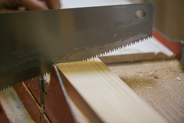 person sawing the wooden plank edge in a factory - Image