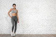 © Art_Photo - Sport woman in sportswear relax stand after workout against copy space for adding text with white wall background.Diet concept.Fitness and healthy lifestyle