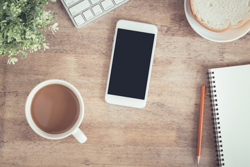 Wall Mural - top view of office table . on desk have notebook coffee cup laptop smartphone and pencil.