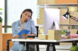 © amenic181 - Young Asian woman entrepreneur/ Business owner working with computer at home
