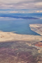 Aerial View From Airplane Of The Great Salt Lake In Rocky Mountain Range, Sweeping Cloudscape And Landscape During Day Time In Spring. In Utah, United States.