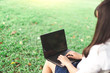 © Savelight Studio - close up hand working women used laptop in the garden checking e-mail business communication