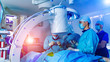 © Vadim - Group of surgeons in operating room with surgery equipment. Medical background