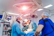 Group of surgeons in operating room with surgery equipment. Medical background