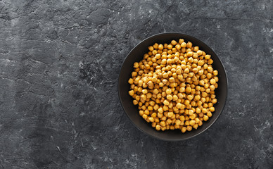 Wall Mural - Cooking chickpeas bowl dark stone background top view