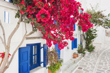 Fototapeta Uliczki - Traditional greek house with flowers in Paros island, Cyclades, Greece