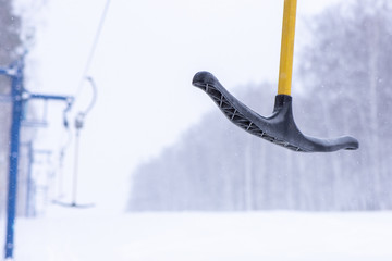 Ski-lift for skiers and snowboarders in winter on a snowy hill in Siberia