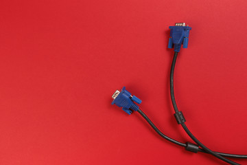 VGA monitor cable on red background