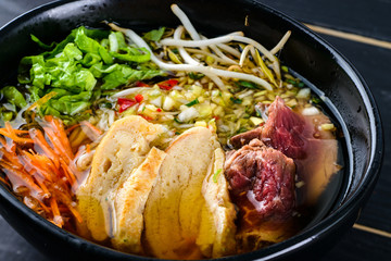 Canvas Print - Spicy Asian beef soup with noodles and chinese vegetables