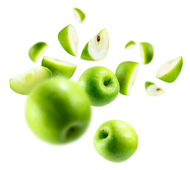 Wall Mural - A group of green apples levitating on a white background
