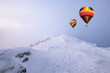 © Mumemories - Colorful hot air balloons flying on snow hill with blizzard