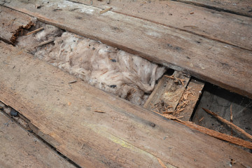 Wall Mural - Old roof repair and renovation. Old house roof with bad wet wooden beams and  wet roock wool insulation material. Roofing construction