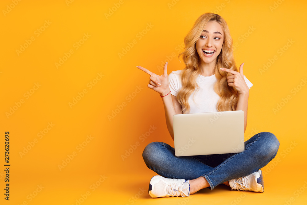 Excited Woman With Laptop Pointing On Copy Space - obrazy, fototapety, plakaty 