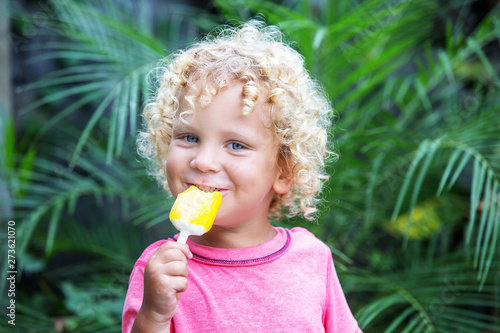 Little Boy With Blonde Curly Hair Is Eating Ice Cream Buy This