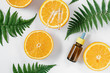 Citrus essential oil, vitamin c serum with fresh juicy orange fruit and leaf fern on white background. Organic Spa Cosmetic With Herbal Ingredients Toning. High dose vitamin c synthetic for skin