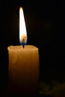 © Andrey - Lonely candle close-up on black background
