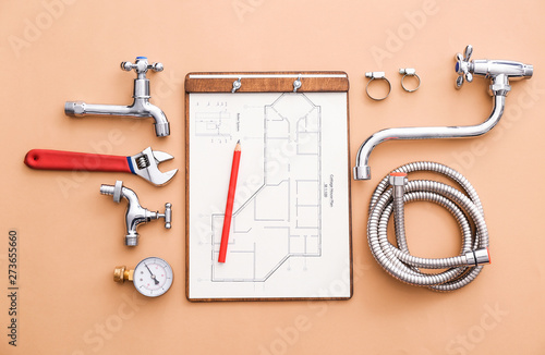 Cuadros en Lienzo Set of plumbing items with house plan on color background